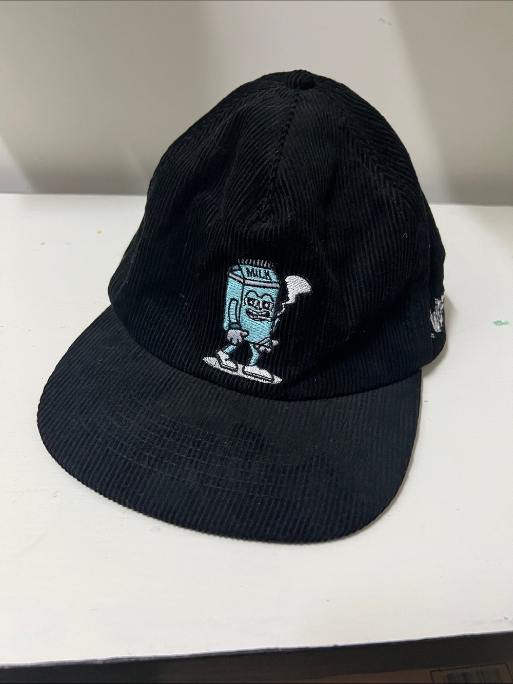Black Corduroy Cap with Embroidered Milk Cartoon